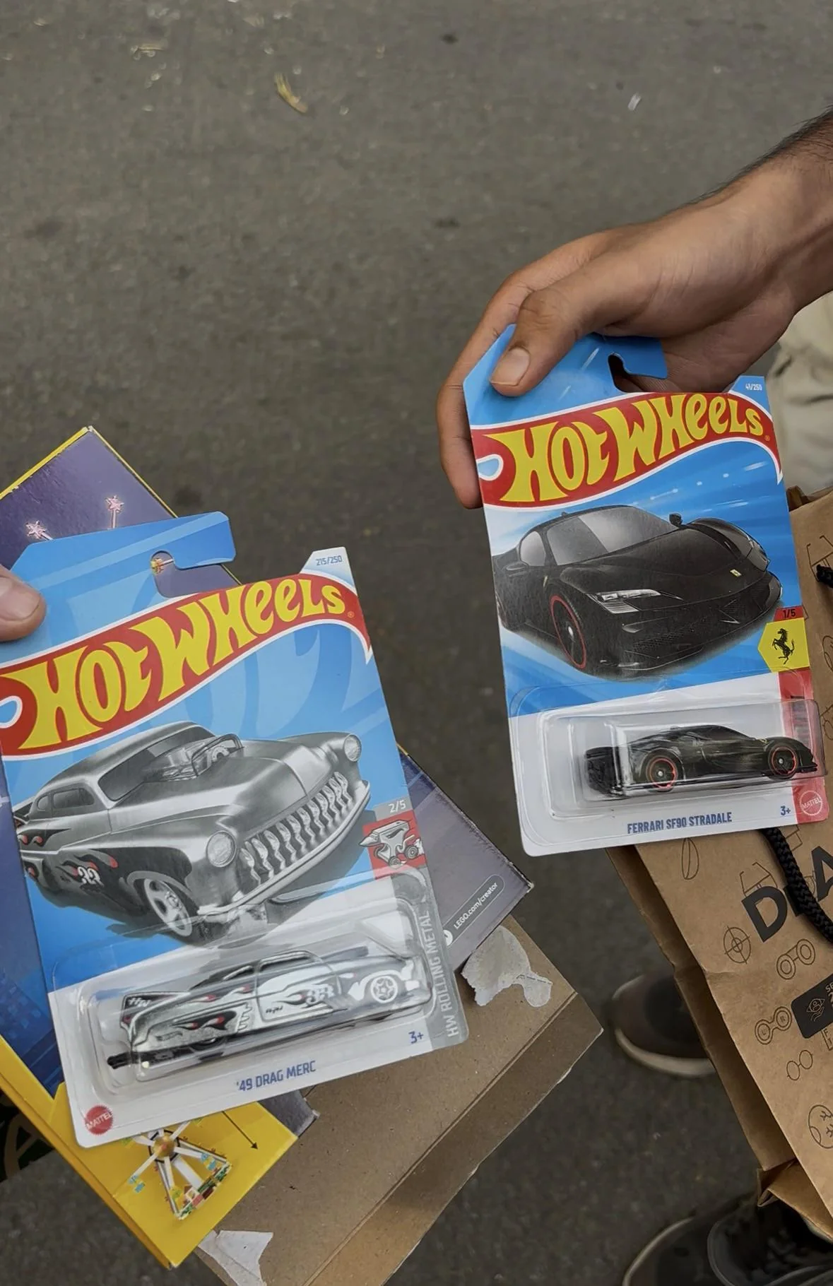 A Hot Wheels car held in hand, part of a Need for Speed trade